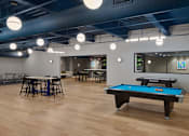 Thumbnail 36 of 54 - A pool table is in the middle of a room with a bar and a ping pong table.