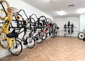 Thumbnail 14 of 17 - A room full of bicycles of different colors and types.