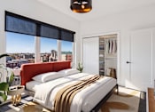 Thumbnail 3 of 32 - A bedroom with a large bed and a view of the city.