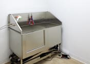 Thumbnail 51 of 54 - A metal table with a white cloth and some objects on it.