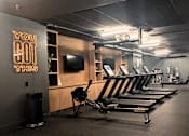 Thumbnail 10 of 17 - A gym with a row of rowing machines and a sign that says "You Got This".