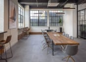 Thumbnail 7 of 16 - a large room with a long wooden table and chairs