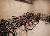 Thumbnail 15 of 32 - A bike rack full of bicycles in a concrete room.