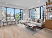 Thumbnail 14 of 42 - A living room with a large window overlooking a city street.