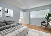 Thumbnail 5 of 13 - a living room with a couch and a chair and a window