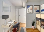 Thumbnail 6 of 13 - a living room with a desk and a chair and a door