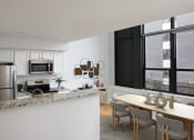 Thumbnail 1 of 13 - a kitchen and dining area with a table and chairs and a refrigerator