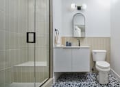 Thumbnail 13 of 17 - a bathroom with a toilet and a sink and a mirror at The Weaver, Philadelphia, PA, Pennsylvania, 19125