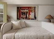 Thumbnail 25 of 30 - A bedroom with a bed and a picture of a bakery on the wall at The PARKER on E Mulberry Apartments, San Antonio, 78209