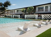Thumbnail 10 of 30 - A row of white lounge chairs are arranged on the edge of a pool at The PARKER on E Mulberry Apartments, San Antonio, 78209