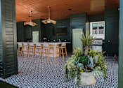 Thumbnail 8 of 30 - A black and white checkered floor with a potted plant in the middle at The PARKER on E Mulberry Apartments, Texas