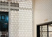 Thumbnail 5 of 30 - A white patterned screen separates the lobby from the office area at The PARKER on E Mulberry Apartments, San Antonio, 78209