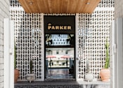Thumbnail 2 of 30 - A white doorway leads to a Parker store at The PARKER on E Mulberry Apartments, San Antonio, Texas