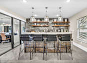 Thumbnail 27 of 46 - a kitchen with a bar and chairs in front of a window at Sunset Ridge, San Antonio, Texas