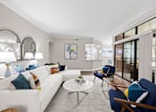 Thumbnail 2 of 48 - Modern living room with sectional sofa and armchairs at Nalle Woods of Westlake Apartments, Austin, Texas
