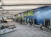 Thumbnail 47 of 87 - a gym with cardio machines and a wall with you are what you are at Beekman on Broadway, Michigan, 48105