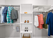 Thumbnail 7 of 48 - Walk-in closet with organized storage and shelving at Nalle Woods of Westlake Apartments, Austin