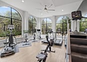 Thumbnail 21 of 48 - Modern fitness center with cardio and strength equipment at Nalle Woods of Westlake Apartments, Austin, TX 78746