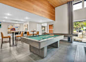 Thumbnail 26 of 46 - play a game of pool in our clubhouse at our apartments at Sunset Ridge, Texas, 78209