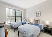 Thumbnail 78 of 87 - Two beds in a room with a window overlooking a snowy landscape.