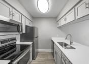Thumbnail 7 of 30 - Apartment kitchen with stainless steel appliances