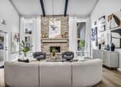 Thumbnail 17 of 41 - a living room with a large couch and a stone fireplace
