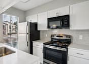 Thumbnail 14 of 31 - Kitchen with cabinets at Keller Oaks, Carrollton, TX