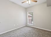 Thumbnail 40 of 54 - A room with a ceiling fan and a window with blinds.