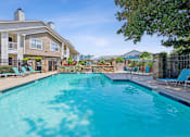 Thumbnail 1 of 29 - A swimming pool in front of a residential building.