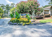 Thumbnail 16 of 29 - A street sign for "Briar Hill" is surrounded by a flower bed.