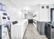 Thumbnail 14 of 41 - a laundry room with a bunch of machines in it