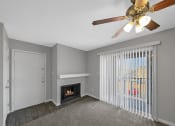 Thumbnail 24 of 37 - a living room with a fireplace and a ceiling fan
