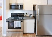Thumbnail 13 of 21 - a kitchen with stainless steel appliances and a stove and refrigerator