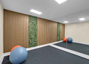 Thumbnail 10 of 20 - A room with a green carpet and a wall with a green plant on it.