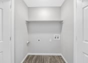 Thumbnail 27 of 37 - an empty room with white walls and wood flooring and a white wall with a