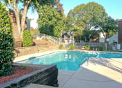 Thumbnail 3 of 21 - a swimming pool in a yard with a house and trees