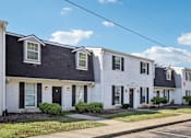 Thumbnail 26 of 58 - A row of houses with white and black exteriors.
