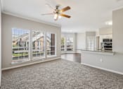 Thumbnail 46 of 54 - A spacious room with a ceiling fan and large windows.