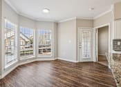 Thumbnail 47 of 54 - A room with wooden floors and a large window.