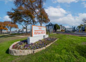 Thumbnail 1 of 37 - the avenue apartments sign in front of grass and flowers