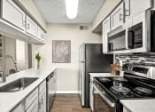Thumbnail 4 of 16 - a kitchen with stainless steel appliances and white cabinets at The Hudson, Carrollton Texas?