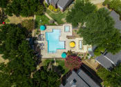 Thumbnail 10 of 37 - an aerial view of a backyard with a large swimming pool with blue and yellow umbrellas