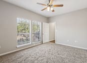 Thumbnail 50 of 54 - A room with a ceiling fan and a sliding glass door.