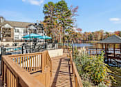 Thumbnail 20 of 32 - Wooden deck overlooks a lake at Radbourne Lake Apartments, North Carolina, 28269