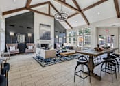 Thumbnail 14 of 54 - A large open living room with a fireplace and a dining table.
