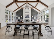 Thumbnail 13 of 54 - A large dining room with a wooden table and chairs.