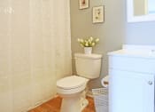 Thumbnail 16 of 21 - a bathroom with a white shower curtain and a toilet
