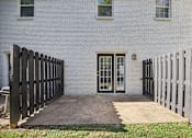 Thumbnail 55 of 58 - A white house with a black fence and a glass door.