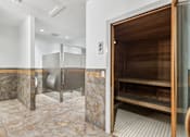 Thumbnail 19 of 54 - A bathroom with a walk-in shower and a wooden door.