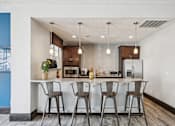 Thumbnail 26 of 32 - Kitchen with bar area and bar stools at Radbourne Lake Apartments, Charlotte, North Carolina